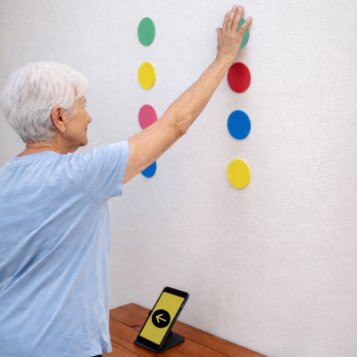 Hand touching coloured wall targets
